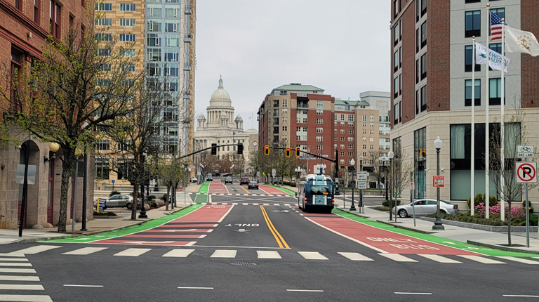 Bicycle signal faces, red colored transit lanes and green bicycle lanes in downtown Providence, Rhode Island 