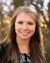 Woman wearing dark jacket and shirt outdoors