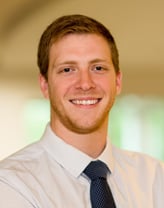 Branden Roberts smiling in white shirt and tie.