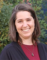 Charlene smiling in an outdoor setting