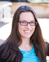 Kaitlin O'Shea smiling in a black jacket and blue dress.