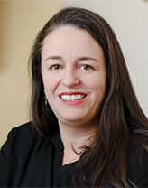 Laura smiling in an office setting