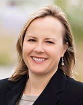 Woman wearing black suit in an outdoor setting