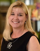 Shannon Julien smiling in a black dress.