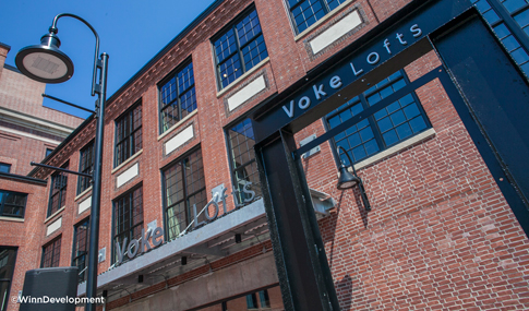 Close-up view of the Voke Lofts sign over the main entrance door in Worcester, Massachusetts.