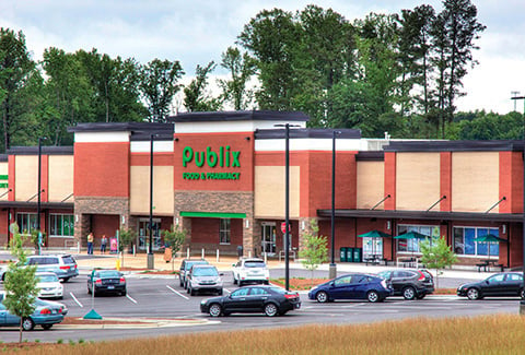 Publix grocery store storefront and parking lot in Apex, North Carolina.