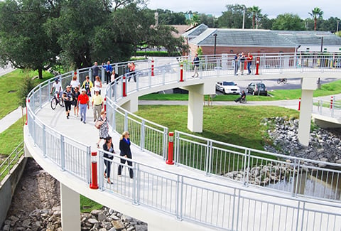 Pedestrians on the Kissimmee Trail Bridge cross on helical approach ramps.