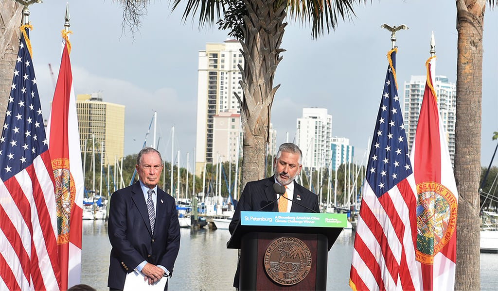 St. Petersburg Mayor Rick Kriseman accepts the American Cities Climate Challenge award from Michael Bloomberg at Albert Whitted Park in January 2019.