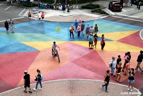 People cross an artistically painted intersection in St. Petersburg.