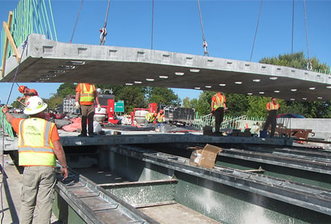 Construction personnel move part of the bridge deck into place during the Colchester Bridge replacements.