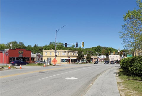 Existing conditions of Route 202 intersection with stoplights and buildings prior to improvements.