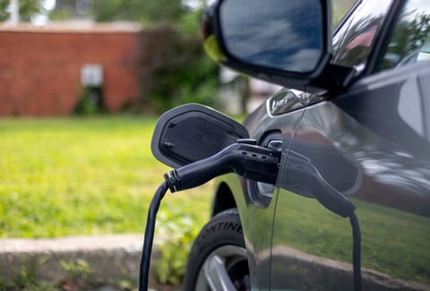 An electric vehicle plugged into a charging station.