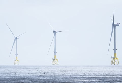 Wind turbines at electric power farm in the North Sea in Aberdeen for renewable energy production and environment conservation