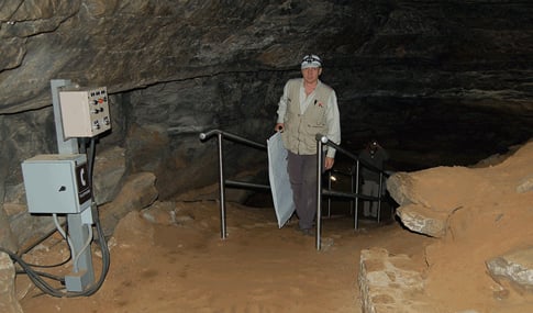 A man walks up a trail inside Mammoth Caves