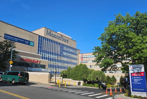 Exterior of a hospital emergency department and tower.