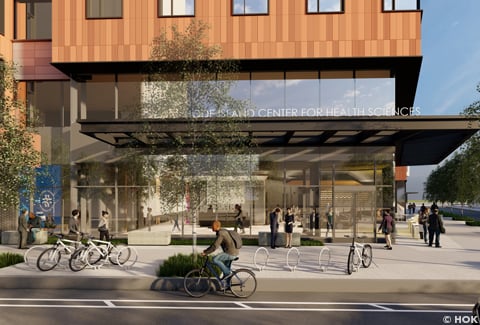 A multi-story building with glass street level and terracotta siding on the upper levels.