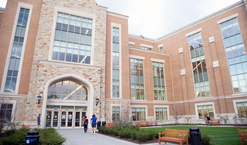 People walking into the front entrance of the Margot Connell Recreation Center.