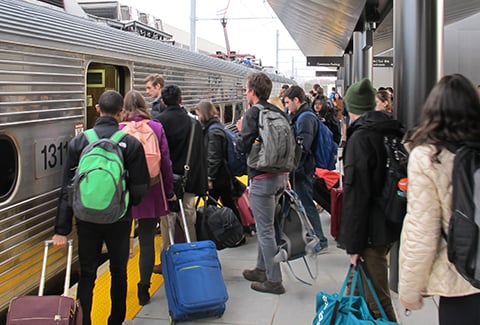 Students board train at Dinky station.