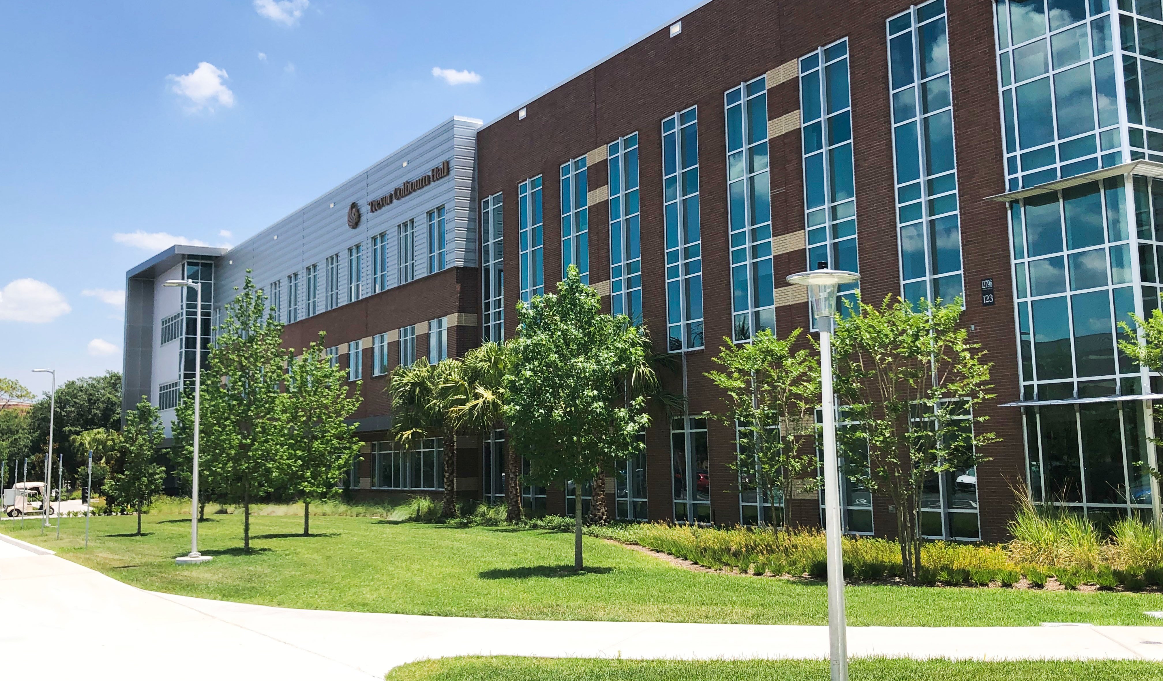 Green trees line the front of Trevor Colbourn Hall.