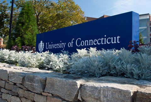 Blue entrance sign to the University of Connecticut.