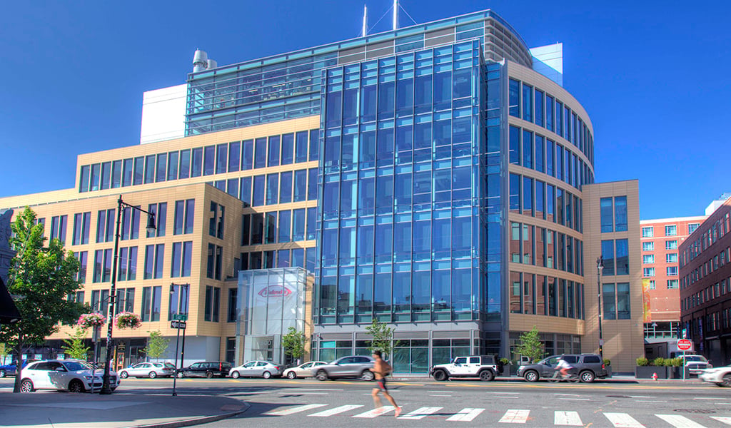 A jogger runs past Takeda’s new facility at 300 Massachusetts Avenue in Cambridge.