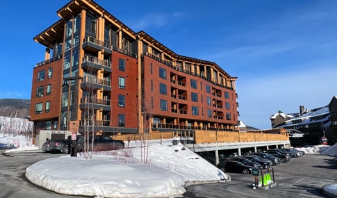 Snowy view of One Spruce Peak residences and penthouses.