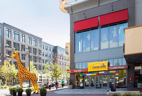 A giraffe statue welcomes visitors outside of the Lego store at Assembly Row.