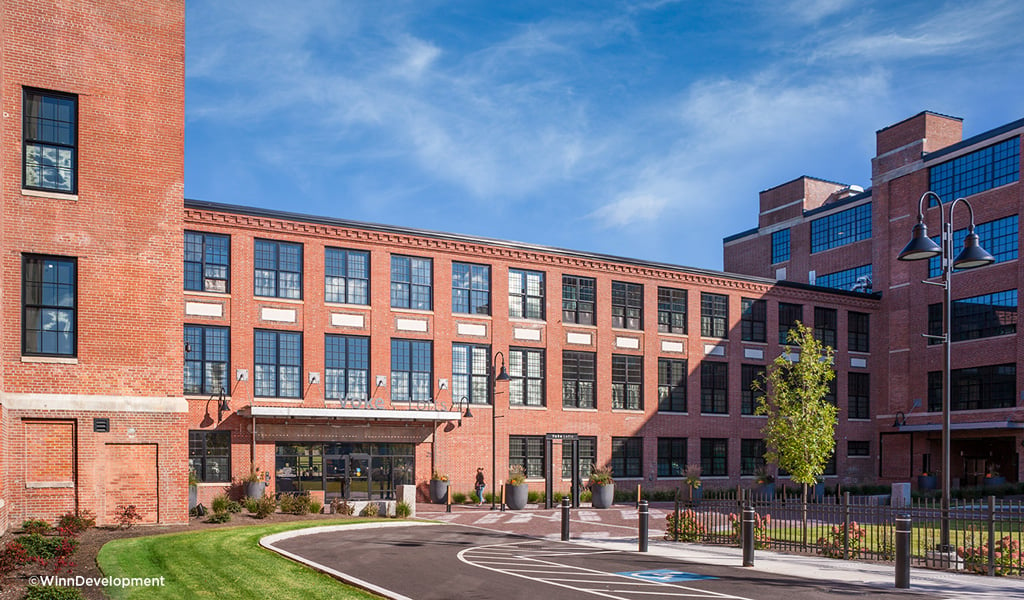 Sun shines on the central courtyard entrance at Volk Lofts in Worcester, Massachusetts.