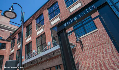 Close-up view of the Voke Lofts sign over the main entrance door in Worcester, Massachusetts.