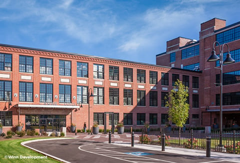 Sun shines on the central courtyard entrance at Volk Lofts in Worcester, Massachusetts.