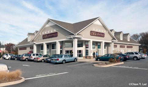 Exterior of a modern CVS/pharmacy location & parking lot.