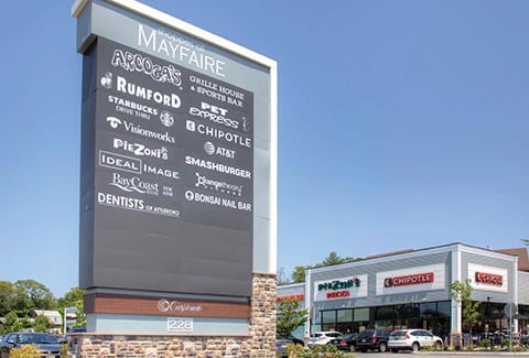 Entryway sign showing a list of businesses at the Shoppes at Wayfair in Attleboro, Massachusetts.