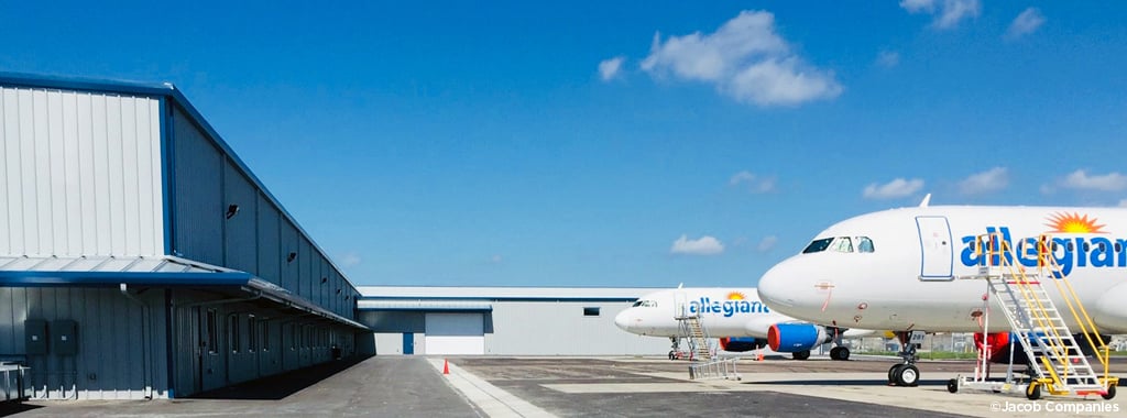 Two Allegiant airplanes sit parked outside the maintenance facility at St. Petersburg-Clearwater International Airport.