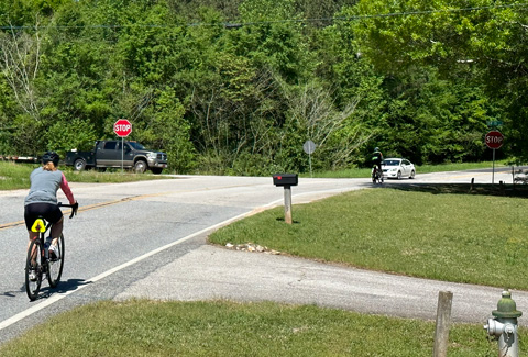A bicycle rider travels a rural Georgia road.