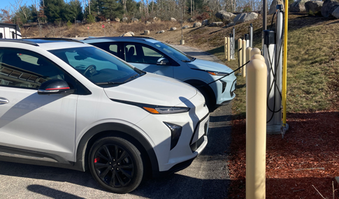 Electric cars plugged into charging stations.