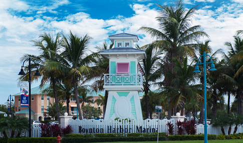 Entry sign to the Marina flanked by palm trees.