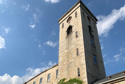 Stevens Mill from below with a blue sky in the background.