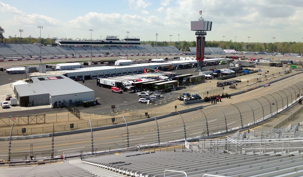 View of the Richmond International Raceway from the stands that shows the track, center leaderboard, and garage area.