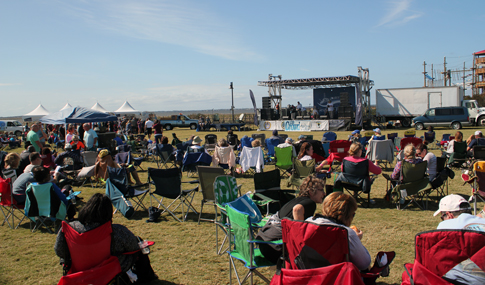Visitors enjoying a live musical performance during the Outer Banks Seafood Festival at the Soundside Event site.