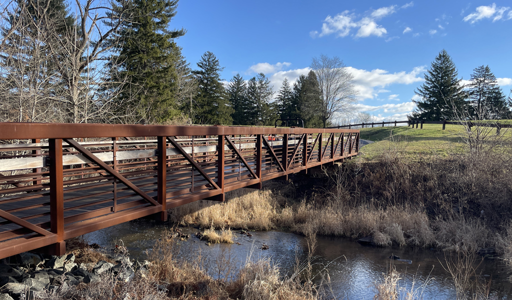 Water flowing under pedestrian bridge at the golf course.