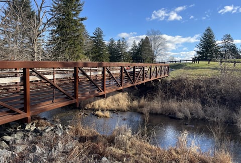 Water flowing under pedestrian bridge at the golf course.