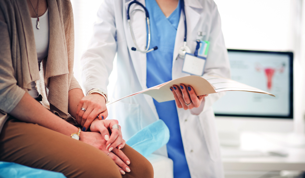 Doctor and patient discussing something in an exam room.