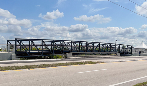 A pedestrian bridge near a busy roadway.