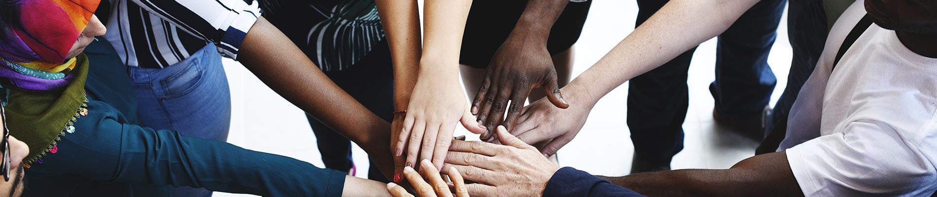 Diversity teamwork with joined hands