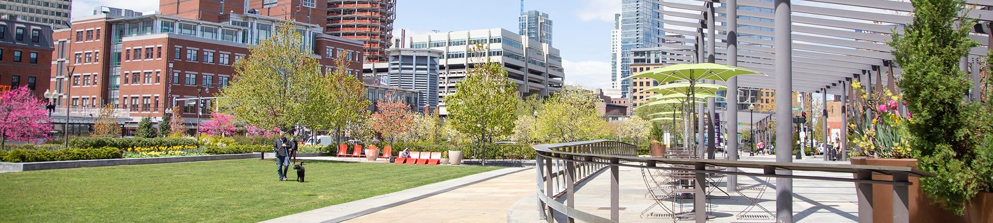 Lush gardens flank a pedestrian walkway in Rose Kennedy Greenway in downtown Boston.