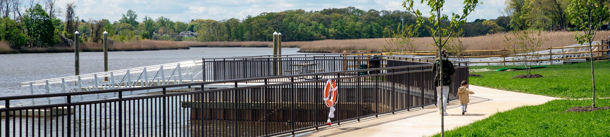 A walking trail and boat ramp at Swimming River Park.