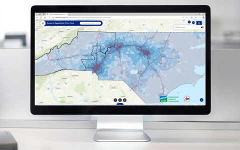 A desktop computer showcases the drive time layer in the web-based app.