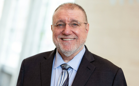 Bob Scopatz smiling in a suit and tie.