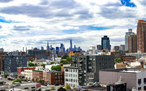 New York City buildings and clouds in the sky.