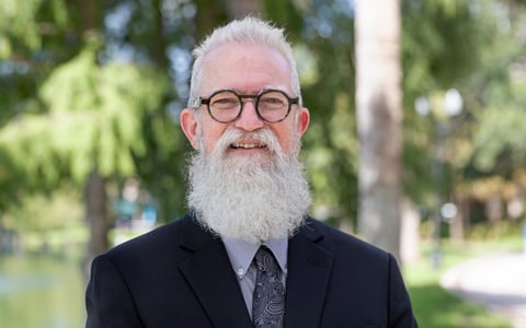 Michael Finch wearing glasses and standing outside.